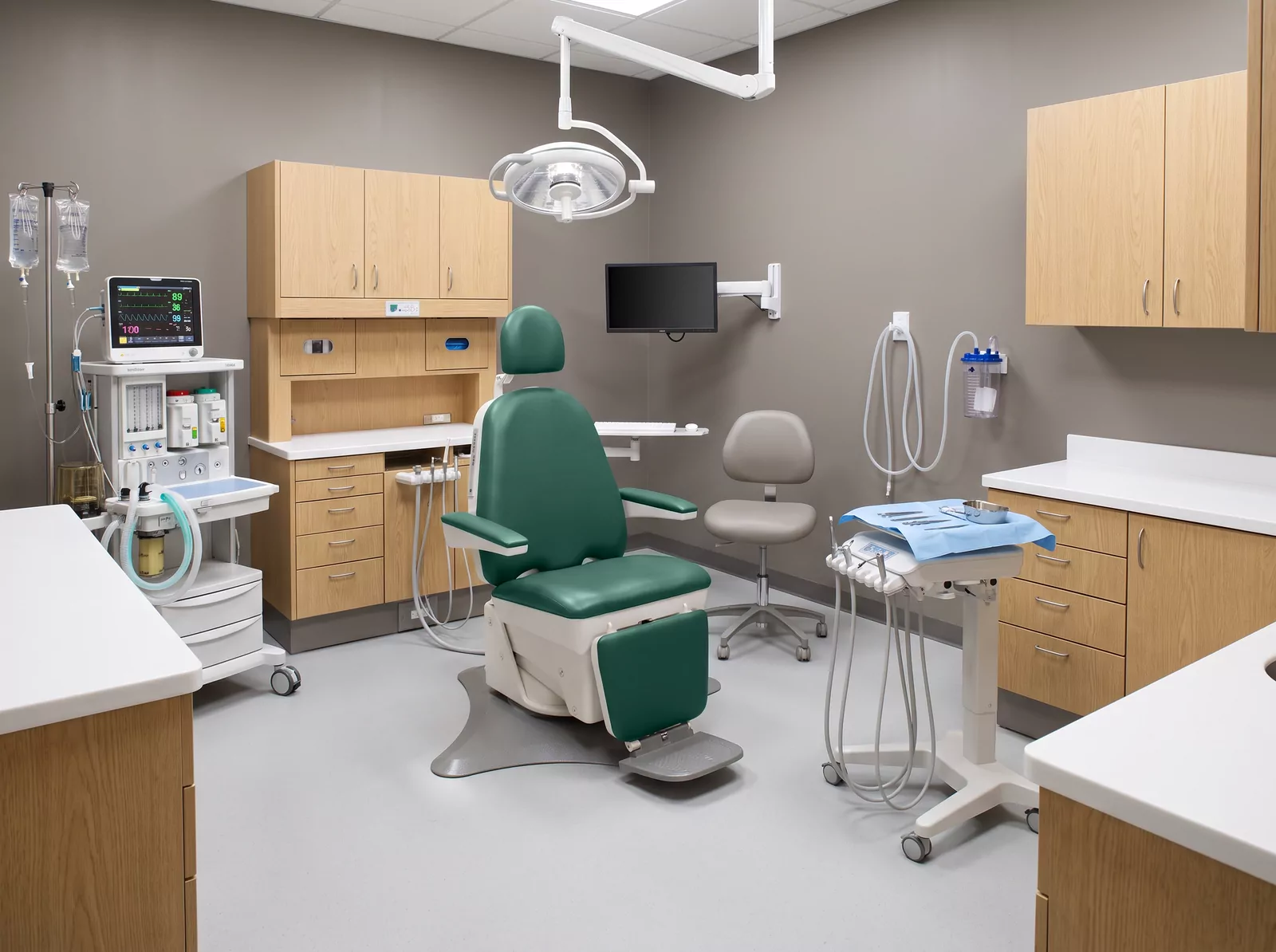 Boyd Industries — a generated operatory: cabinetry, surgical light, monitor arm and anesthesia cart around the chair